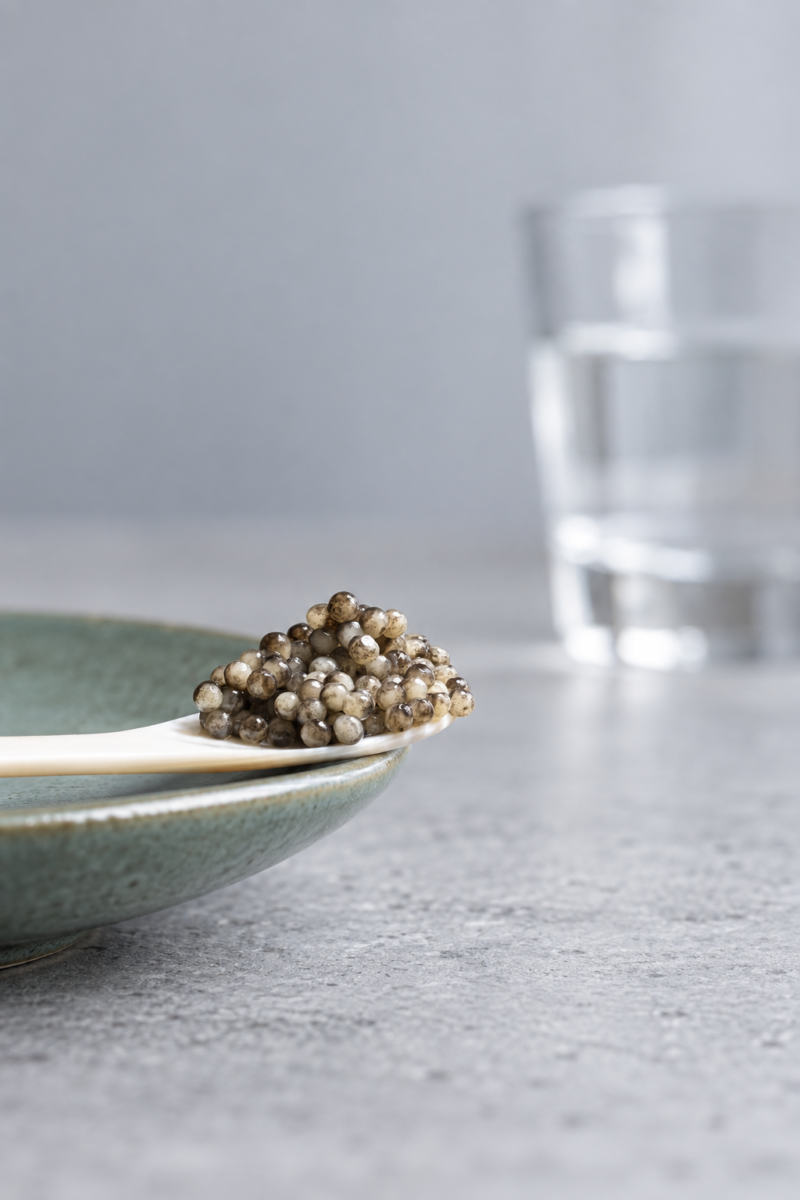 Caviar on a mother-of-pearl spoon and green saucer